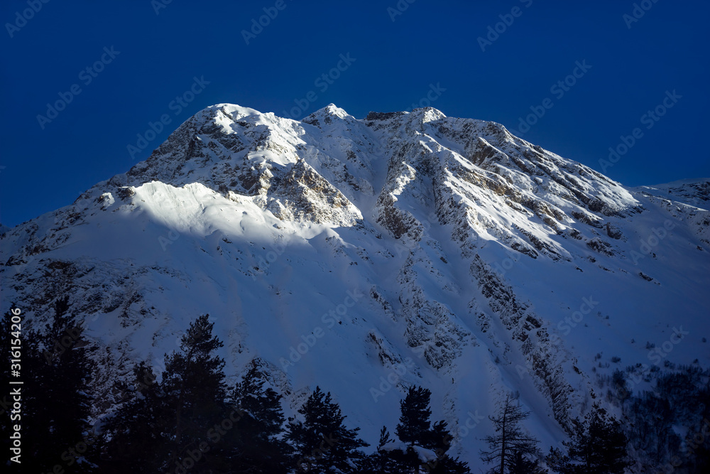 Beautiful silhouette morning landscape of mountains massif on North Caucasus on winter resort