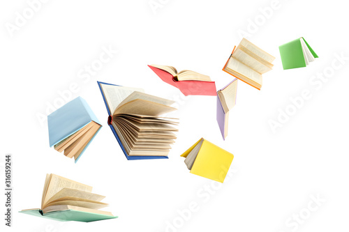 Valokuvatapetti Colorful hardcover books flying on white background