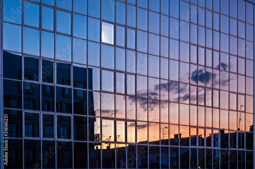 glass facade reflects the sunset
