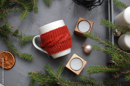 White and red ceramic mug on gray textile background