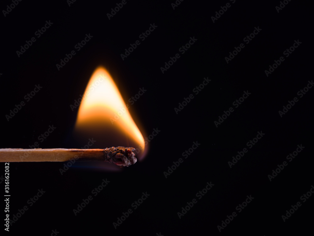 Burning match on black background. Empty with copy space for advert text. Side view Burning match on black background. Empty with copy space for advert text. Side view
