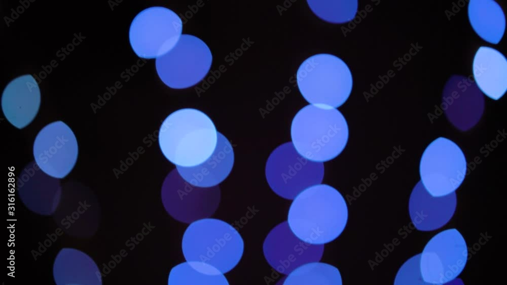 Bokeh blue lights raising up in rows on black background Bokeh blue lights raising up in rows on black background