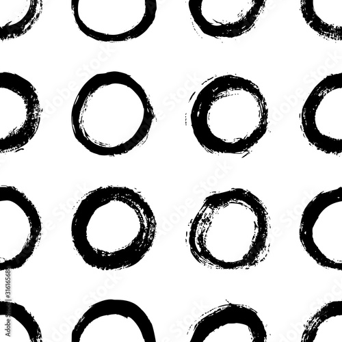 Seamless polka dot pattern hand drawn with a brush. Vector Monochrome Grunge texture of circles. Scandinavian background