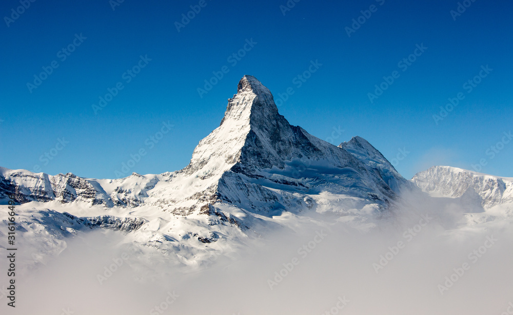 Αυτοκόλλητο Zermatt Matterhorn view mountain winter snow landscape sea of fog clouds sunset