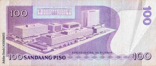 Philippines central bank on 100 piso Philippines money bill close up fragment photo