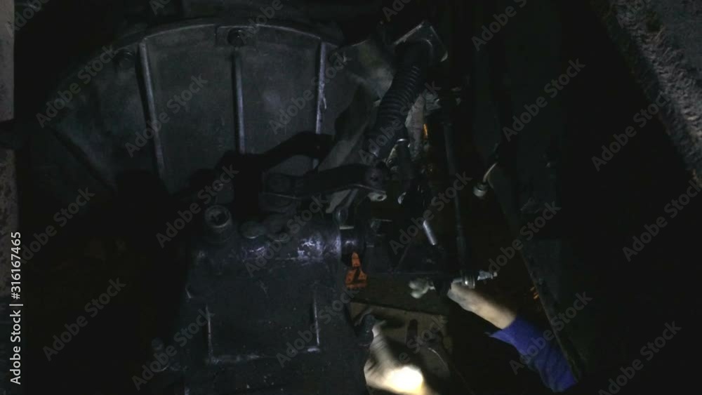 Professional man fix car truck engine in the dark with flashlight. Professional man fix car truck engine in the dark with flashlight.