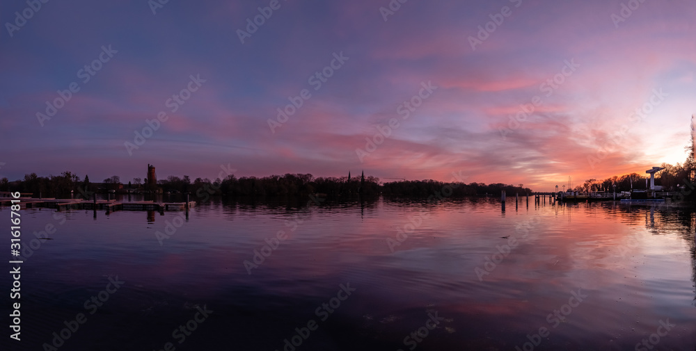Obraz premium Reflection on a lake during colorful sunset, stock image, Potsdam, Germany