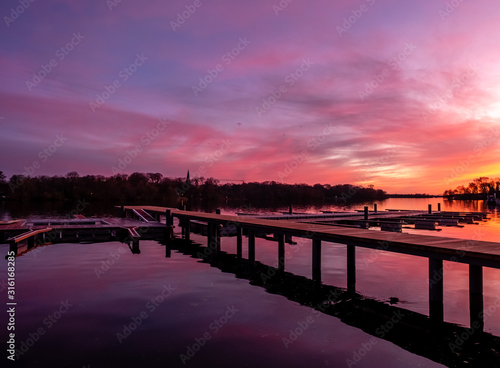 Reflection on a lake during colorful sunset, stock image, Potsdam, Germany