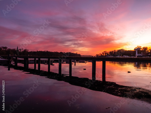 Reflection on a lake during colorful sunset  stock image  Potsdam  Germany