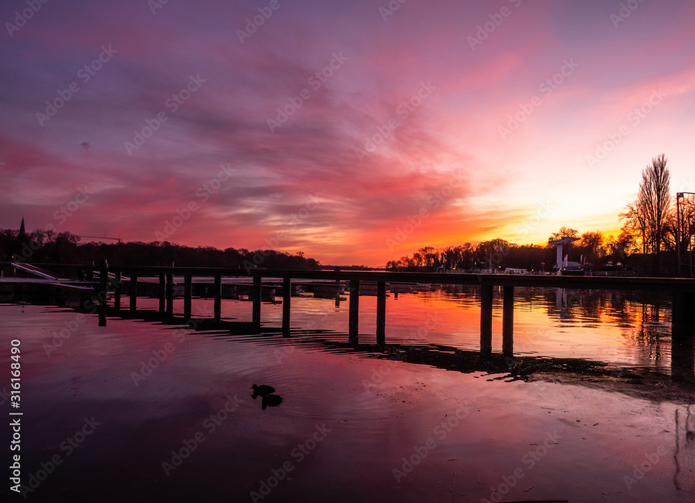 Obraz premium Reflection on a lake during colorful sunset, stock image, Potsdam, Germany