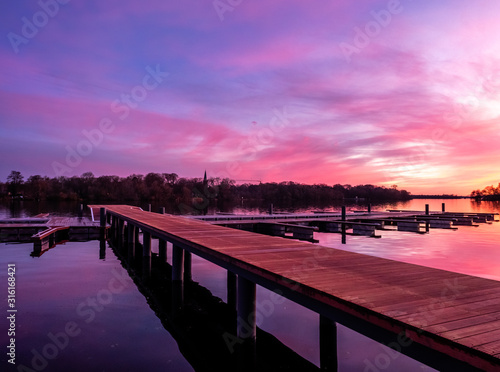 Reflection on a lake during colorful sunset, stock image, Potsdam, Germany © alexandernative