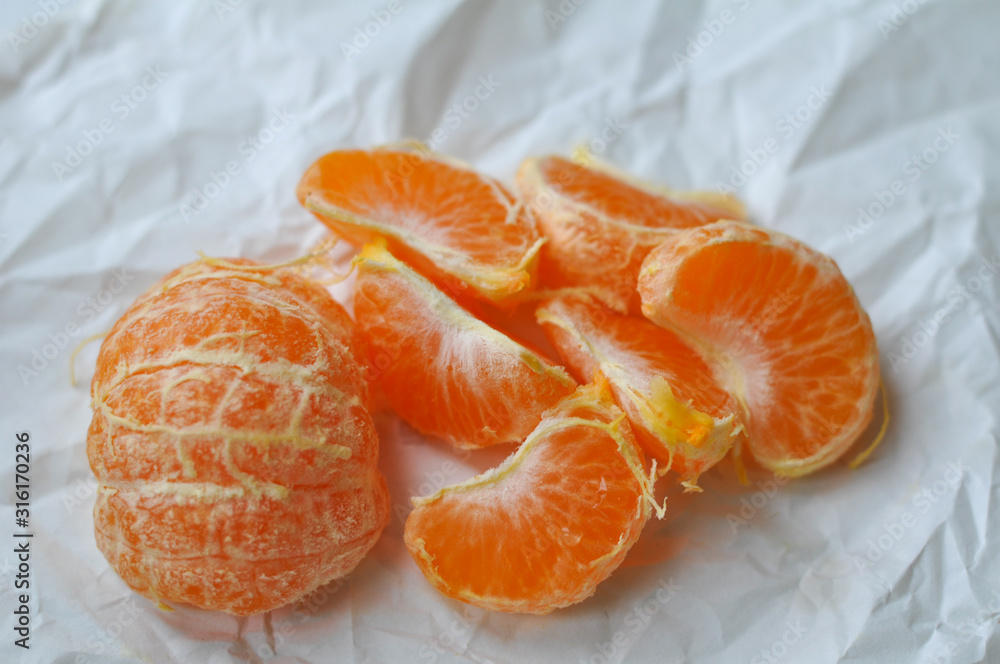 mandarin slices on a white crumpled background mandarin slices on a white crumpled background