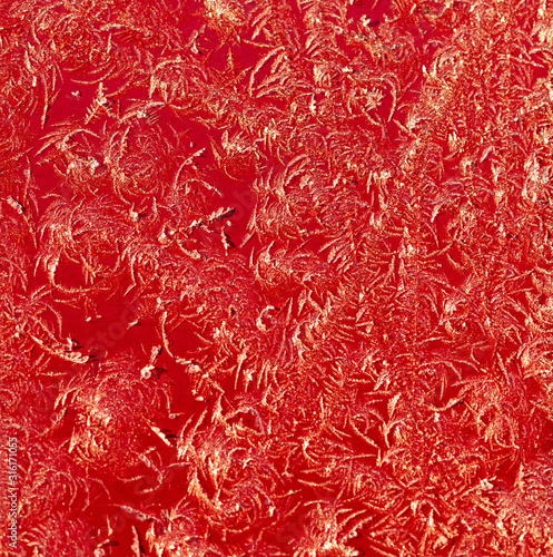 Snowflakes on red metal as a background