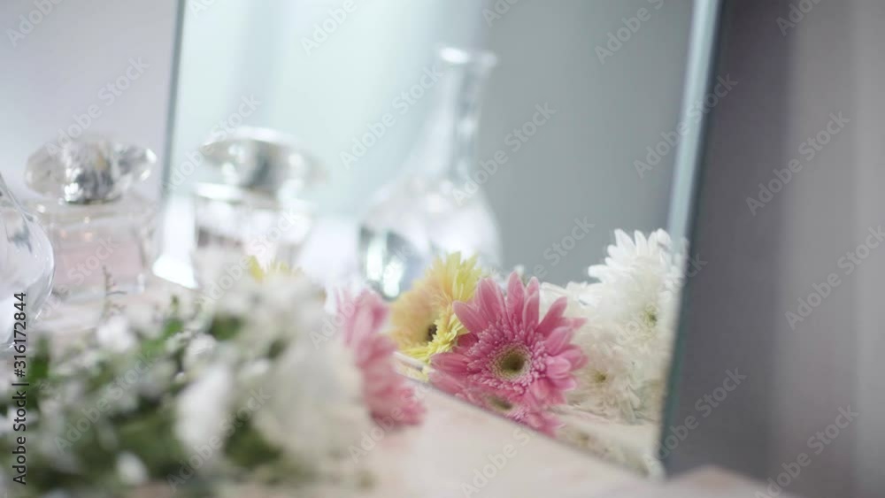 Move Camera From Right to Left, Reflection in Mirror A Bouquet of Bloom White, Pink and Yellow Daisy Flower and Glass Vase and Perfume on Dressing Table Move Camera From Right to Left, Reflection in Mirror A Bouquet of Bloom White, Pink and Yellow Daisy Flower and Glass Vase and Perfume on Dressing Table