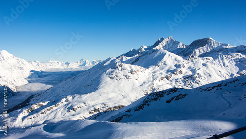 Sea of clouds Zermatt Matter valley and snowy mountains sunset view winter landscape Swiss Alps light © Andreas