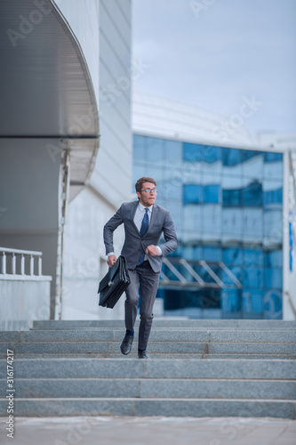 serious business man walking on city street.