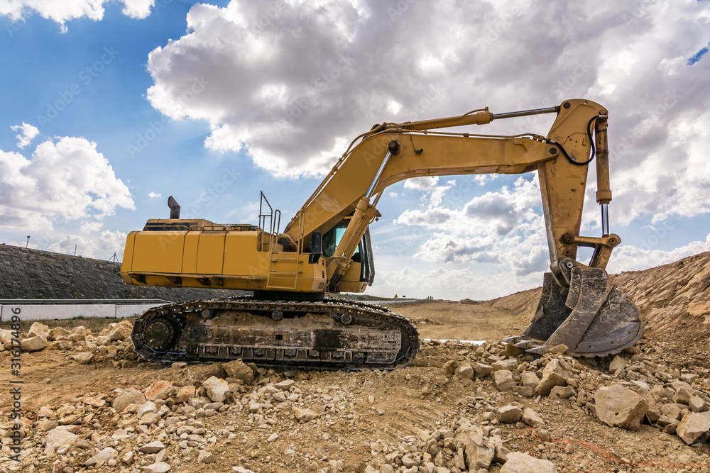 Excavator in a quarry extracting stone Excavator in a quarry extracting stone