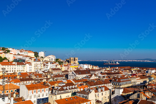 Lisbon skyline with a view at the tagus river and the Cathedral at twilight