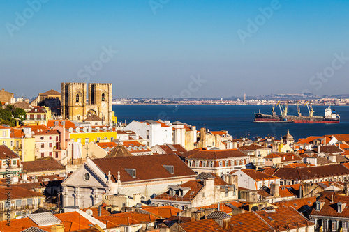Lisbon skyline with a view at the tagus river and the Cathedral at twilight