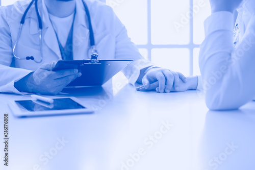 male doctor comforting patient who is in ambulance