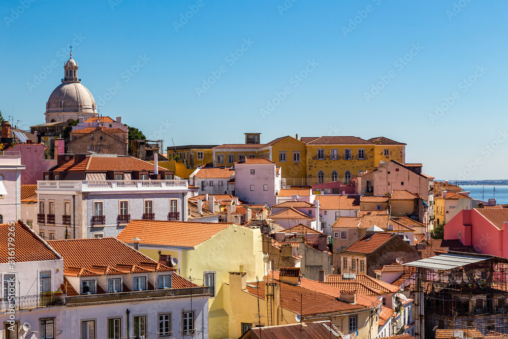 Skyline of Lisbon and the old Alfama district on a summer day with a bright blue sky
