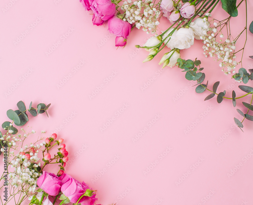 Fototapeta premium Flowers on pink background with copy space