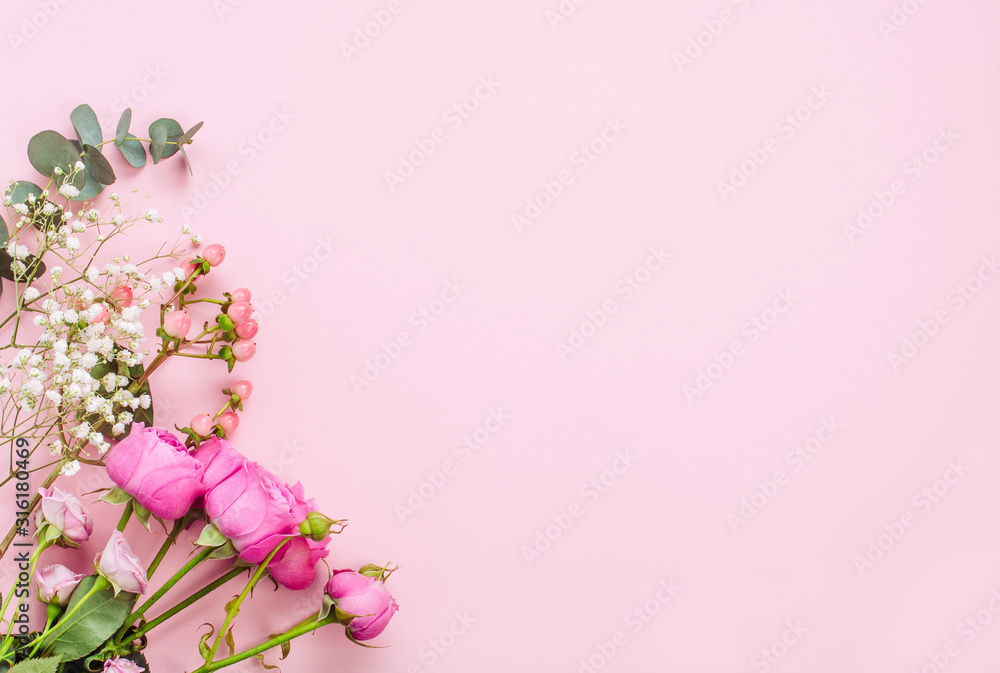 Fototapeta premium Flowers on pink background with copy space