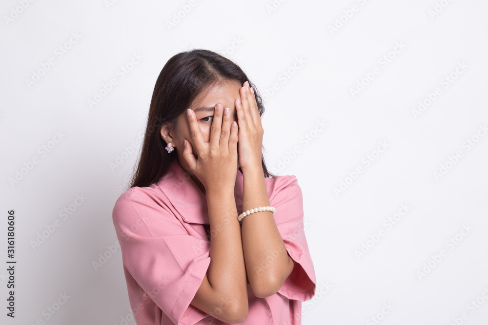 Beautiful young Asian woman peeking through fingers. Beautiful young Asian woman peeking through fingers.