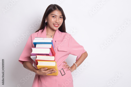 Young Asian woman studying with may books.