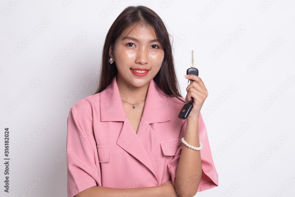 Cute asian girl showing home residence keys. Cute asian girl showing home residence keys.