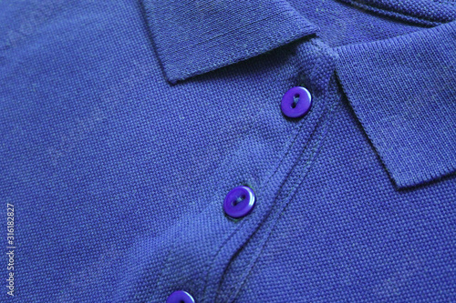 Blue polo shirt close up view of casual button down cotton top. Minimalist polo t-shirt design, simple short sleeve tee front. Men and women stylish blue top, low angle view 