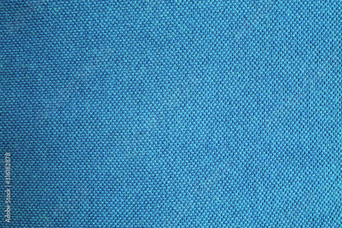 Gradient blue texture background with azure, turquoise and carolina color shades. Light to dark blue tone banner, grainy fabric canvas pattern, empty cloth detail wallpaper 