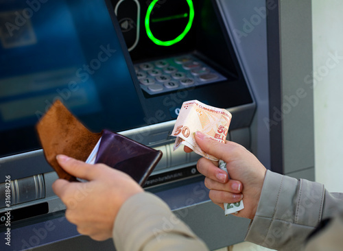 Photography Turkish lira holding money to ATM