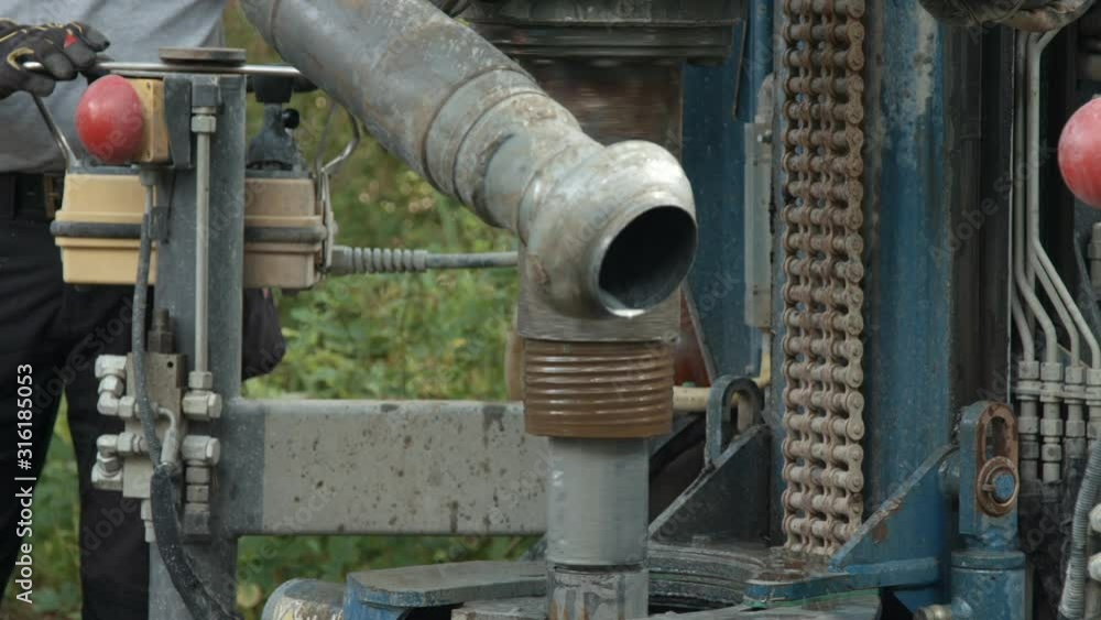 Water well drill rig pulling out drill pipes after drilling groundwater borehole Water well drill rig pulling out drill pipes after drilling groundwater borehole