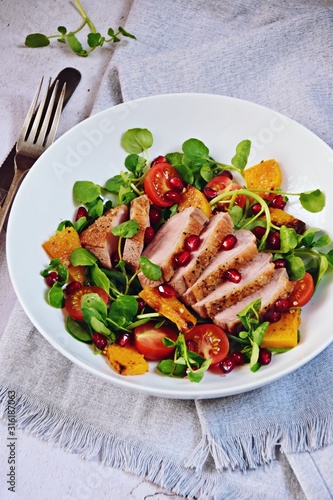 Duck breast fillets steak salad with roasted pumpkin, tomatoes and pomegranate seeds