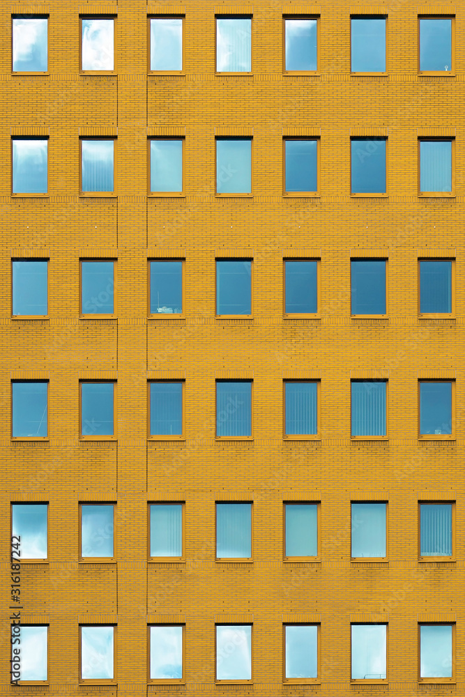 Windows of a yellow brick building texture. Abstraction. Windows of a yellow brick building texture. Abstraction.