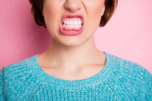 Cropped close-up view portrait of her she nice attractive fury evil cruel woman grinning teeth healthy gums anti caries isolated over pink pastel color background photo