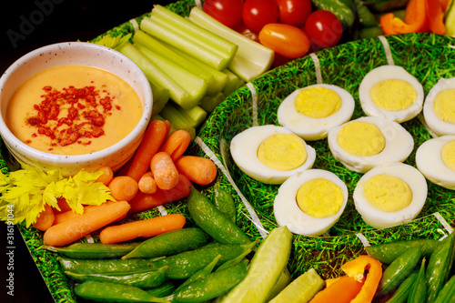 Boiled eggs with vegetable platter and dipping sauce, ranch.