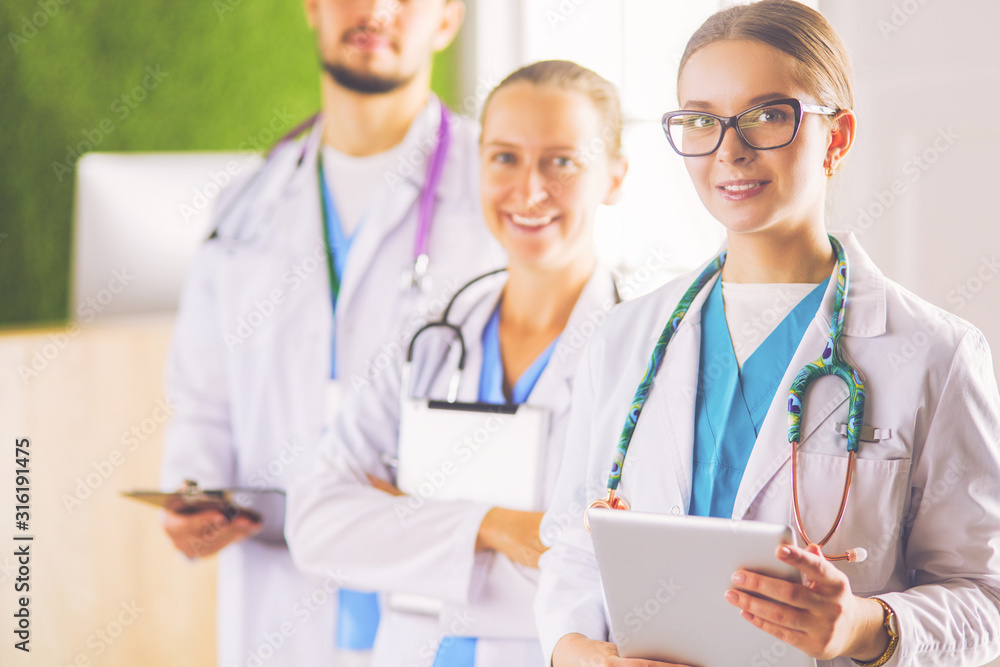Group of doctors and nurses standing in the hospital room Group of doctors and nurses standing in the hospital room
