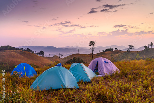 Camping site with tents on green grass on Sanpakha, Nan, the border of Thailand-Lao