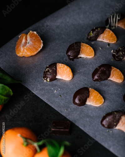 Dark chocolate dipped clementine moody food photography