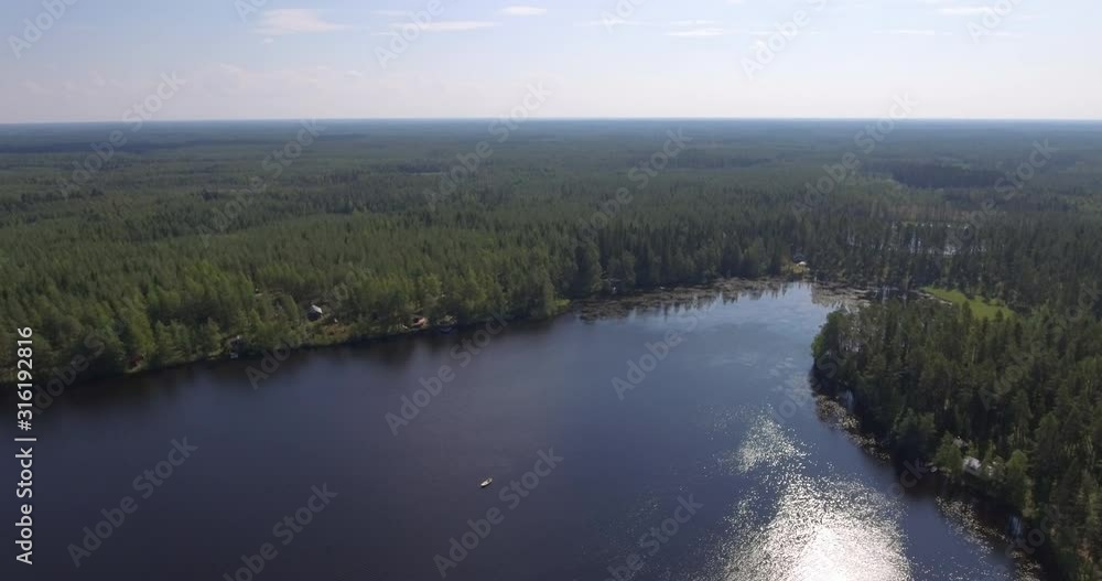 Rowing boat on summer lake. Lake and forest landscape in summer. Rowing boat on summer lake. Lake and forest landscape in summer.