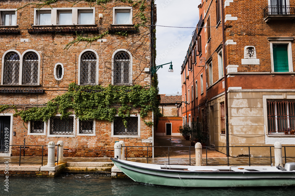 canal, motor boat and ancient buildings in Venice, Italy