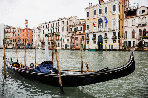 canal with gondola and ancient buildings in Venice, Italy
