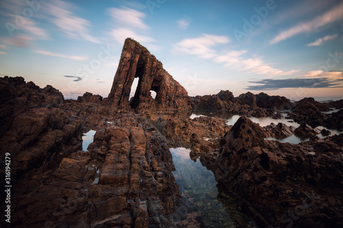 Vallina Beach in Asturias, Spain. Wavy sea and c liff background.