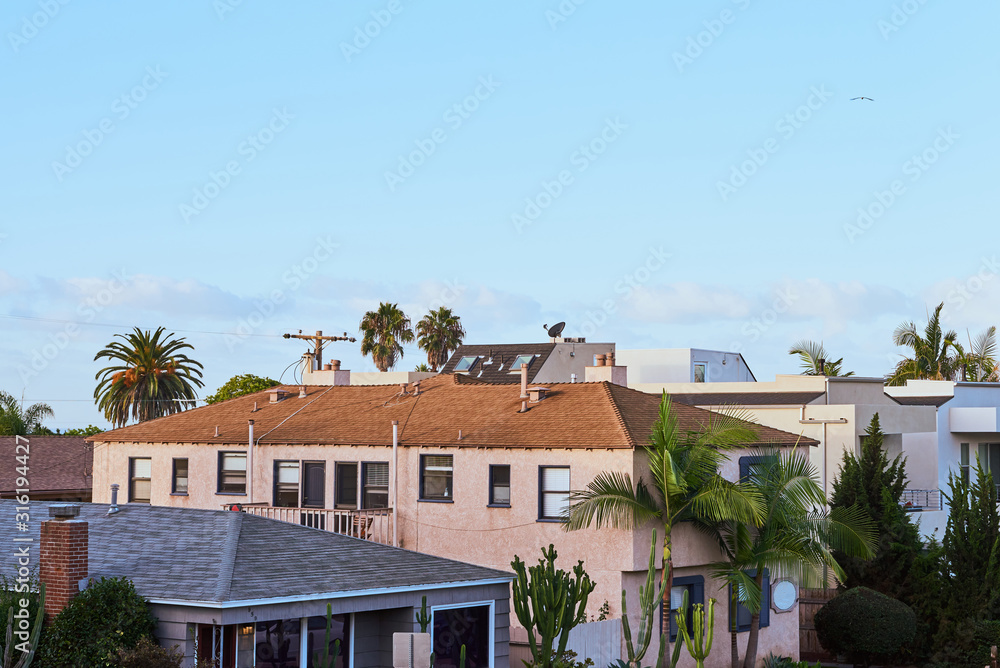 Residential Buildings at sunrise with palms growing in the yard