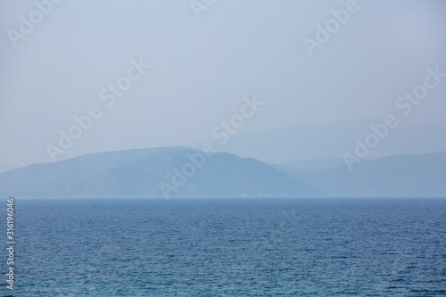 Heavy fog at sea in the predawn hour. Charming monophonic seascape.