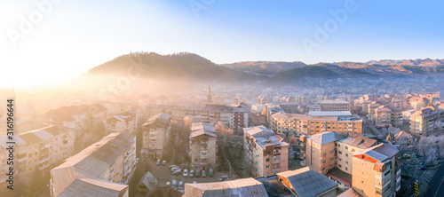 High resolution panorama of small town in the moutains. Foggy morning with negative temperatures at sunrise.