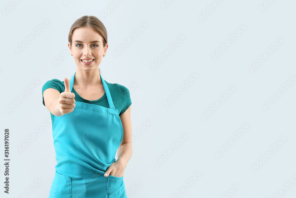 Janitor showing thumb-up on light background Janitor showing thumb-up on light background