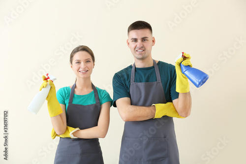Portrait of janitors on light background